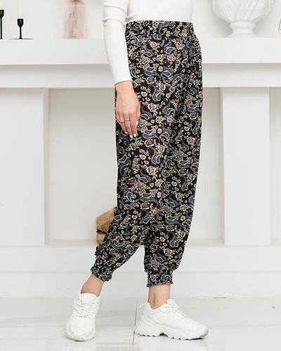 Čierne dámske nohavice s béžovou potlačou PLUS SIZE - Oblečenie