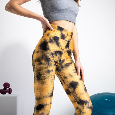 Žlté dámske legíny s ozdobnými škvrnami - Oblečenie