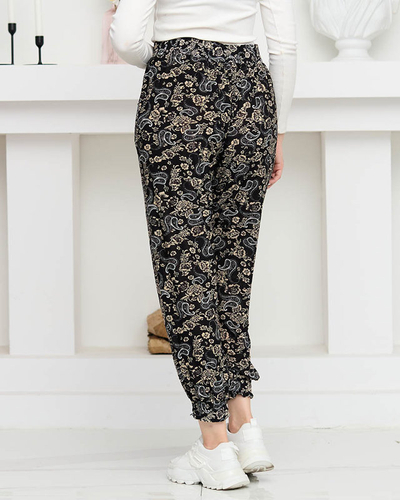 Čierne dámske nohavice s béžovou potlačou PLUS SIZE - Oblečenie